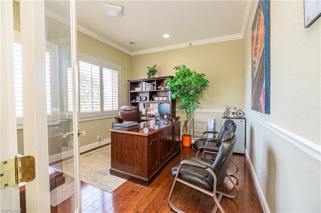Office area with dark wood-style flooring, baseboards, recessed lighting, and crown molding