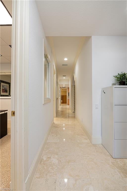 Hall with baseboards and crown molding