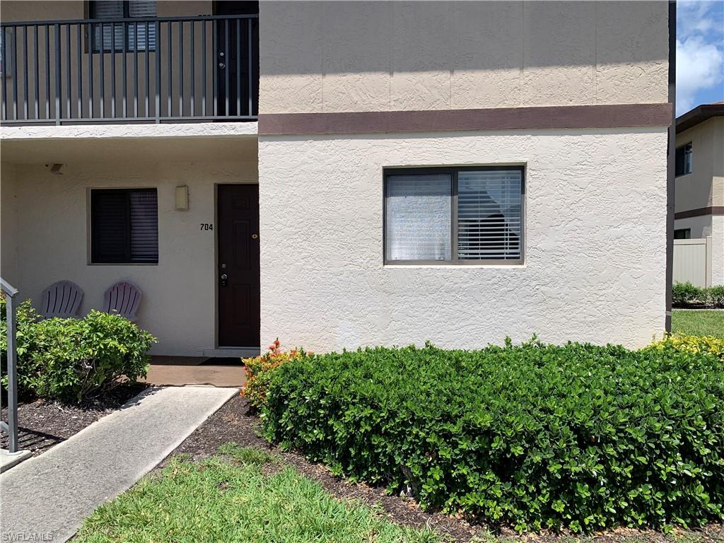 View of first floor exterior entry with stucco siding
