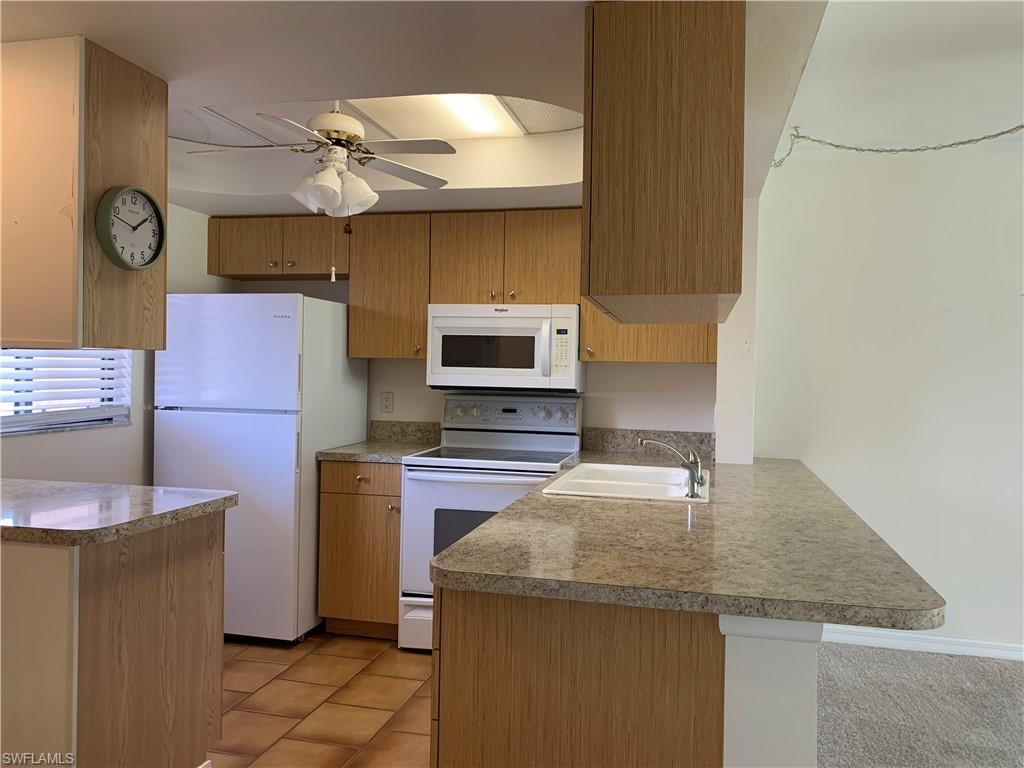 Kitchen with white appliances.
