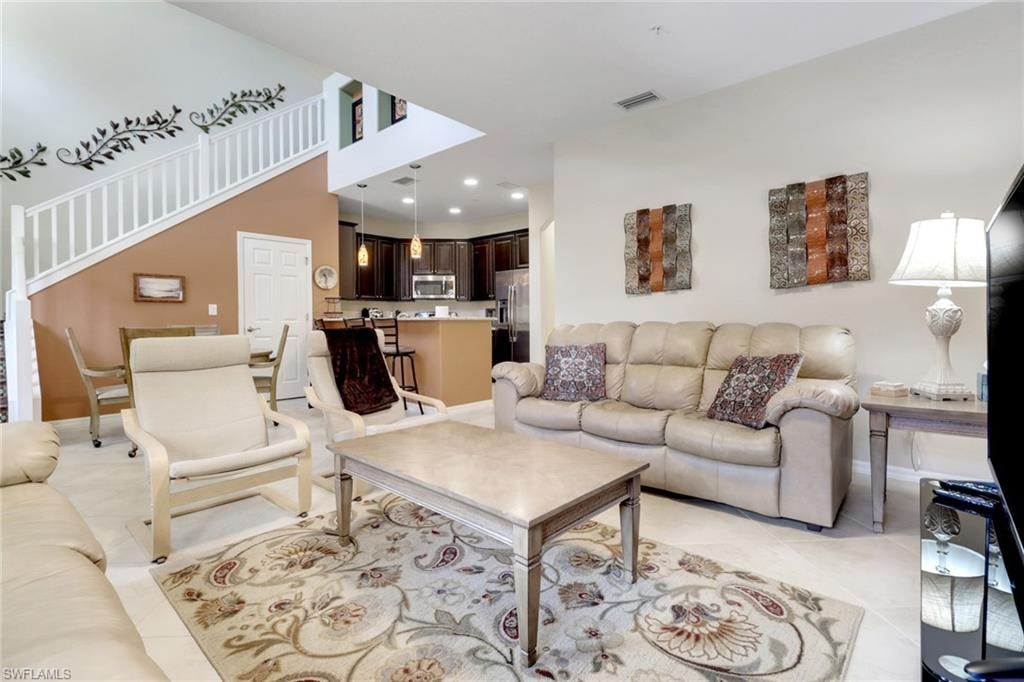 Living area with baseboards, recessed lighting, and light tile patterned floors