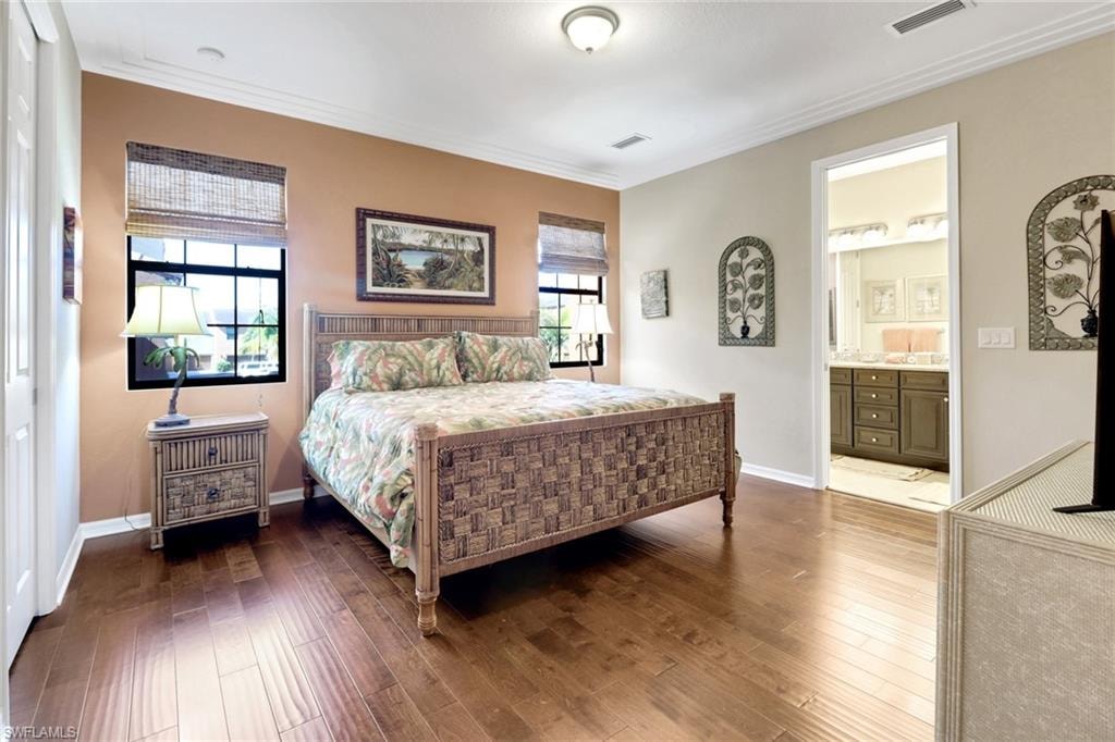 Bedroom featuring  ornamental molding, and wood finished floors