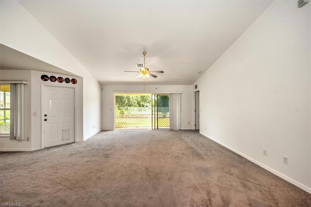 Great room featuring ceiling fan and vaulted ceiling