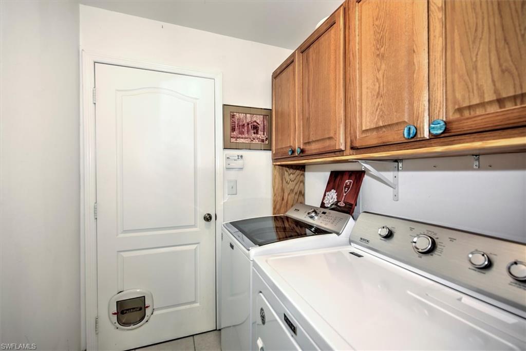 Laundry room featuring cabinets and separate washer and dryer