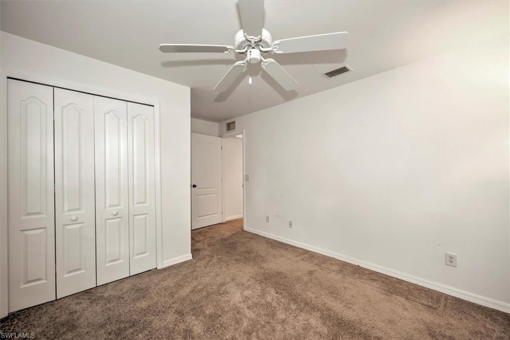 3rd bedroom featuring a closet, ceiling fan, and carpet floors