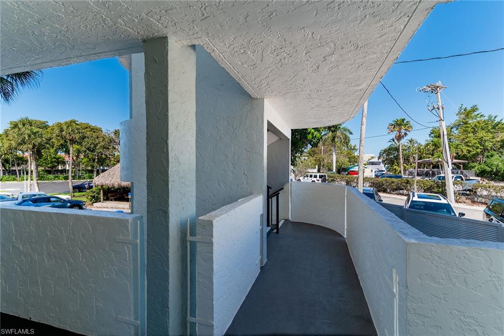 View of side of property featuring a balcony and stucco siding