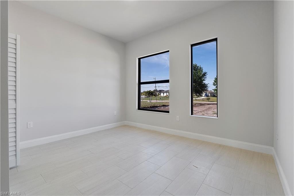Unfurnished room with baseboards