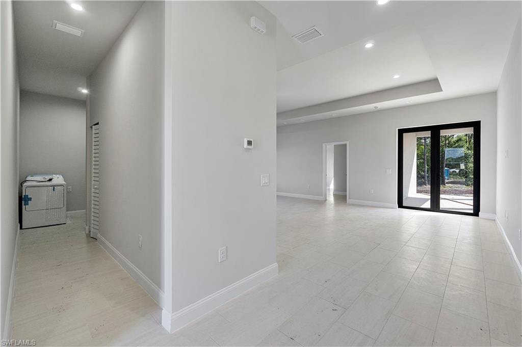 Hallway with washer / dryer and recessed lighting