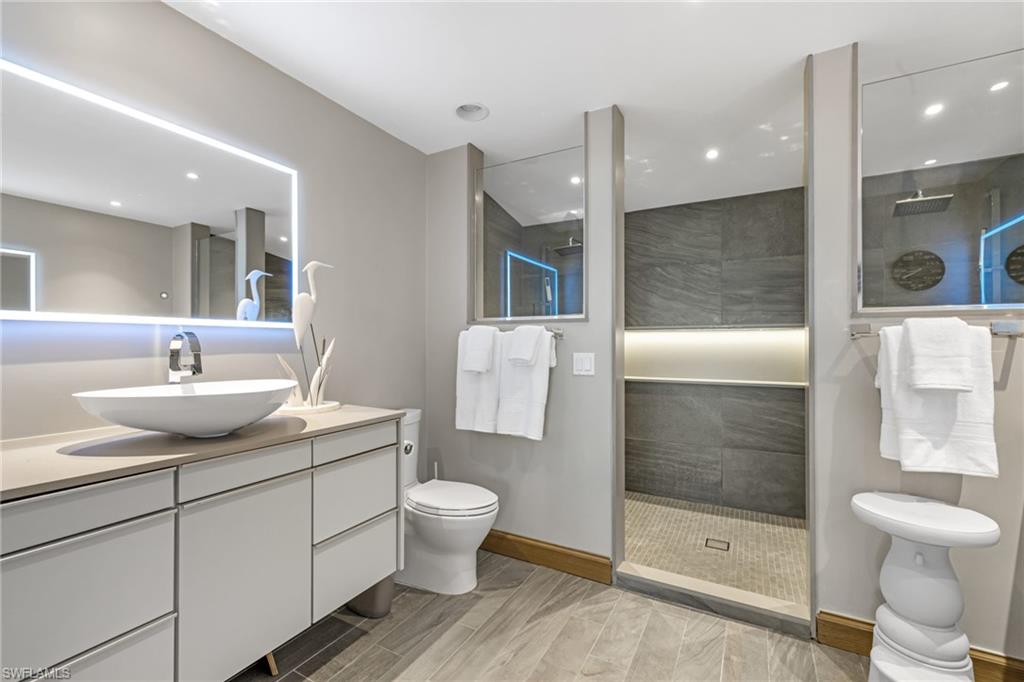 Primary Bathroom with Two Vanities and a Double Walk-in Shower w/ Two Shower Heads