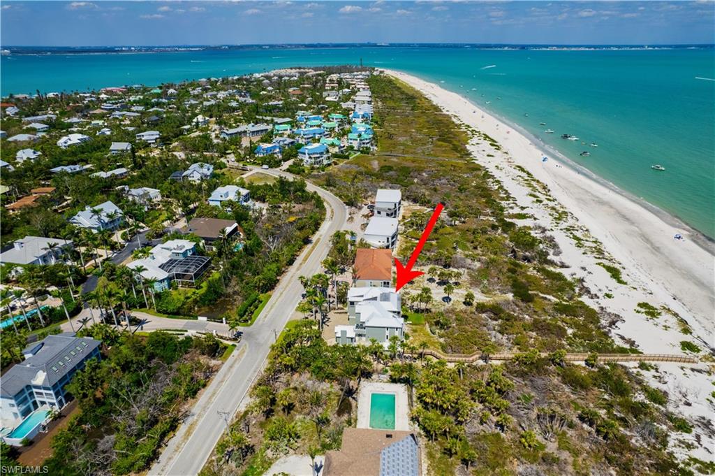 Aerial view with a water view and a view of the beach