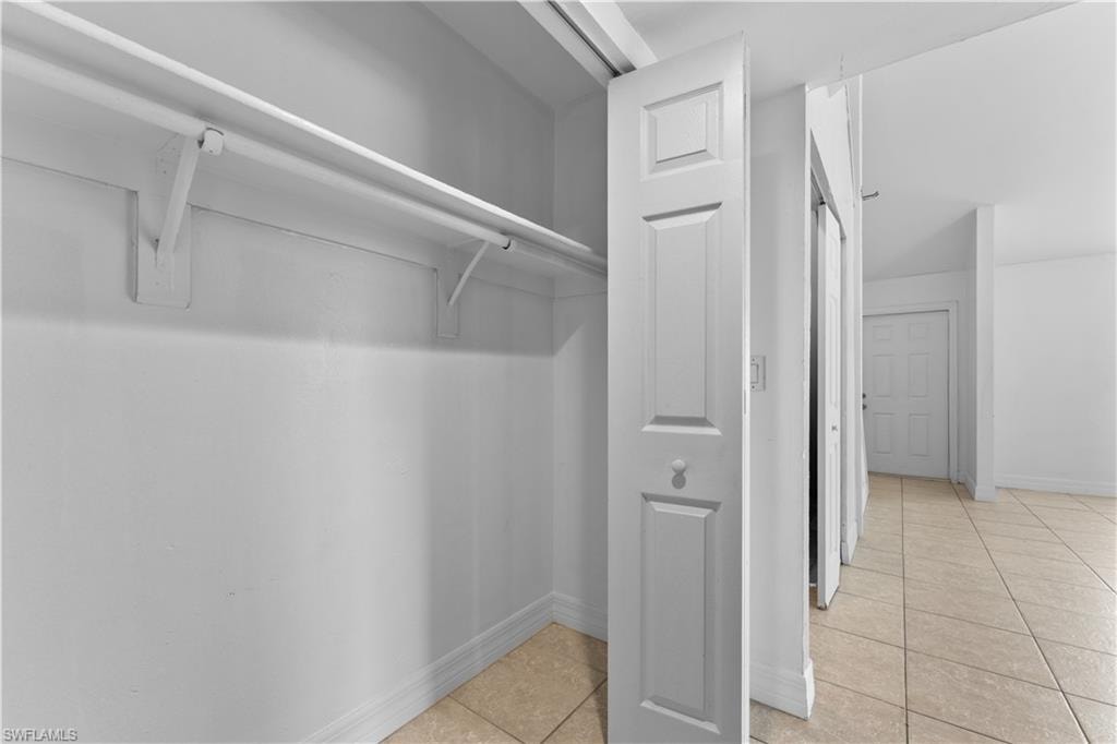 Spacious closet with light tile patterned floors
