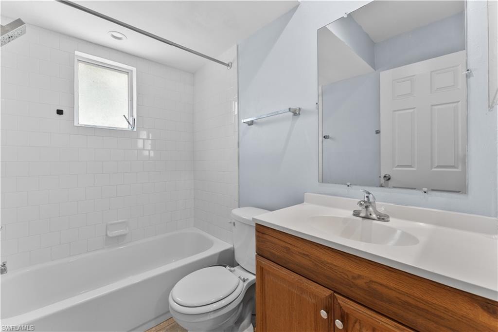 Full bath with shower / bathtub combination, vanity, and toilet