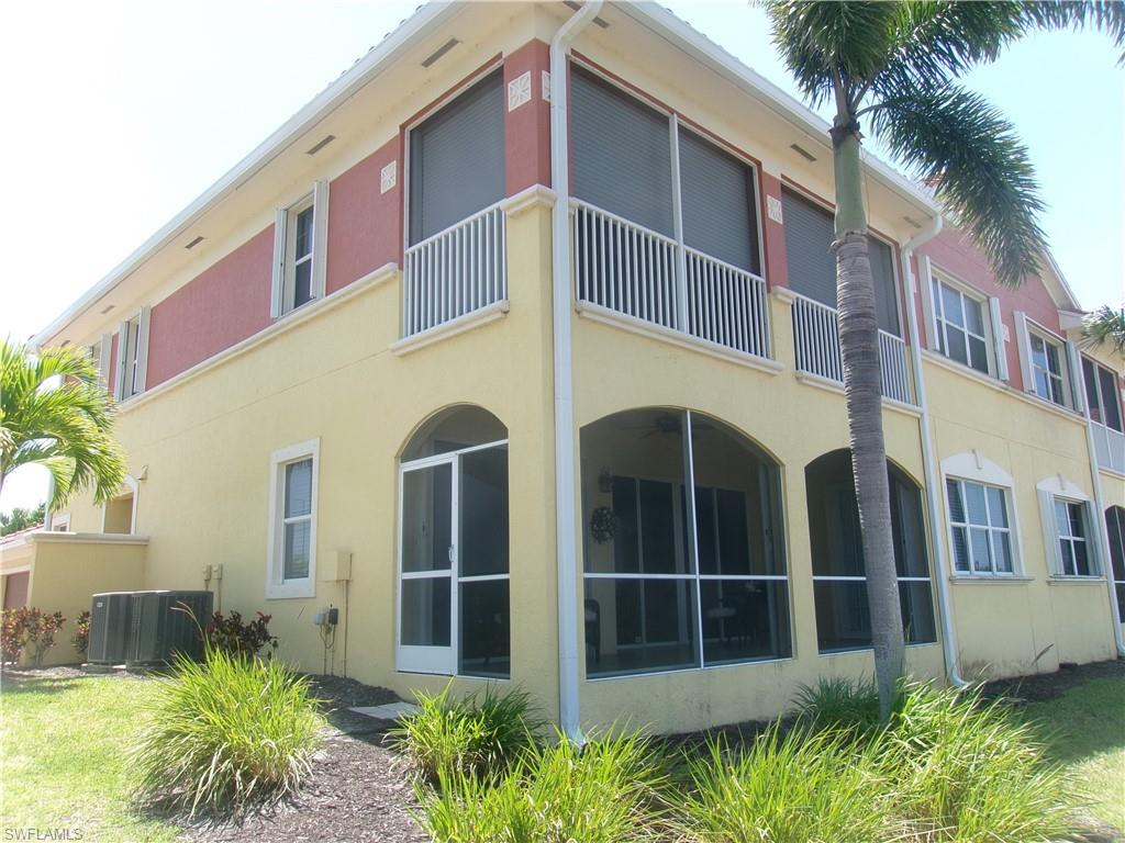 View of building exterior featuring central AC unit
