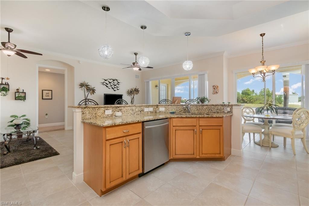 Kitchen featuring stainless steel dishwasher, ornamental molding, a sink, decorative light fixtures, and ceiling fan with notable chandelier