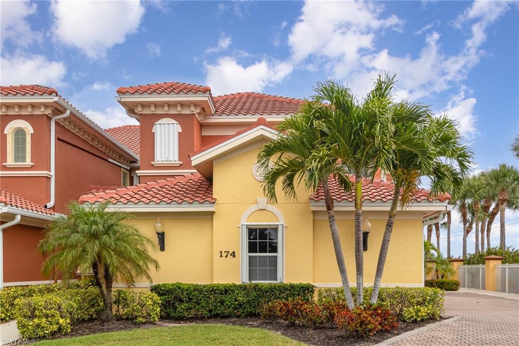 Mediterranean / spanish-style house featuring fence, a tile roof, and stucco siding
