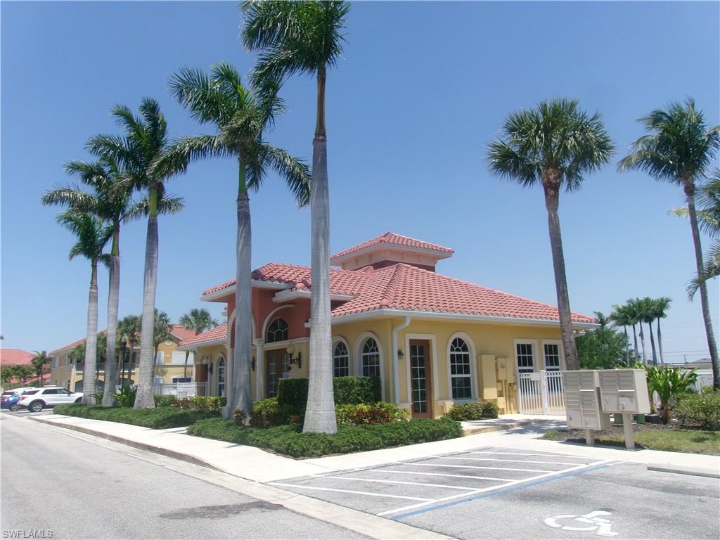View of building exterior with uncovered parking