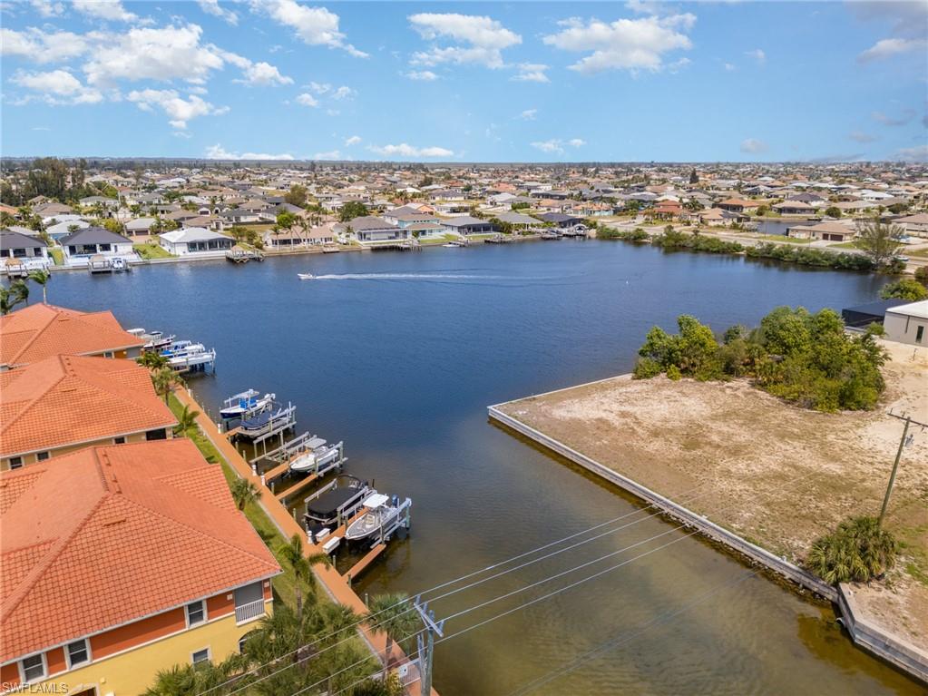 Birds eye view of property featuring a residential view and a water view