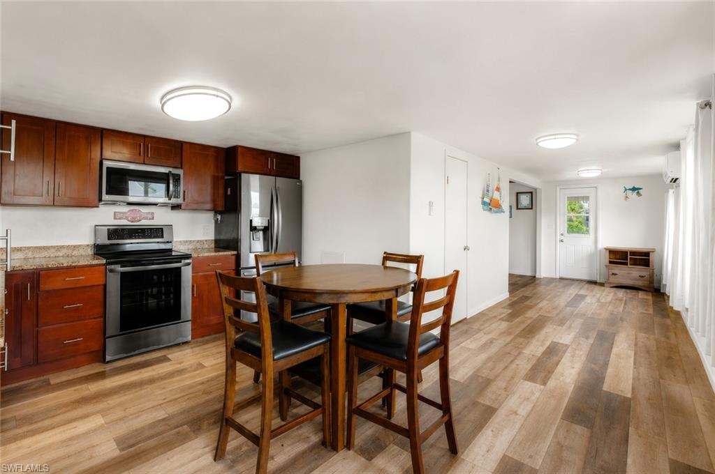 Kitchen featuring wood-finish cabinetry, stainless steel appliances, and a light-toned countertop