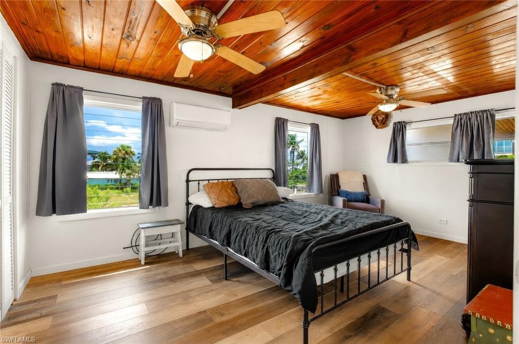 Wood-finish flooring with a wood-paneled ceiling, featuring two ceiling fans with integrated lighting