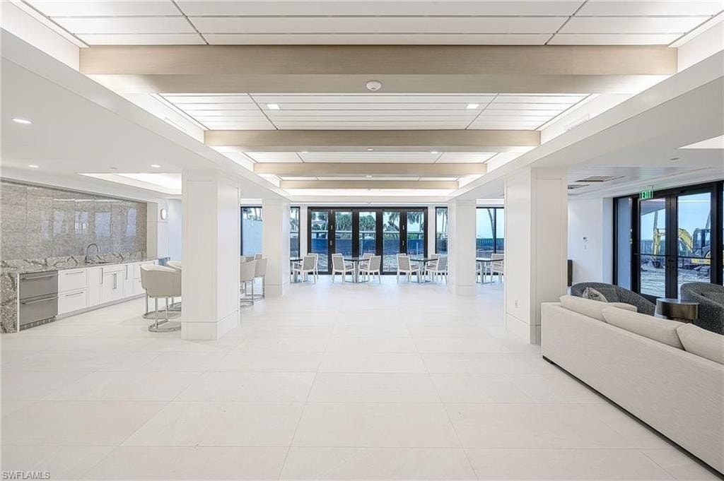 Lobby featuring a wall of windows and beam ceiling