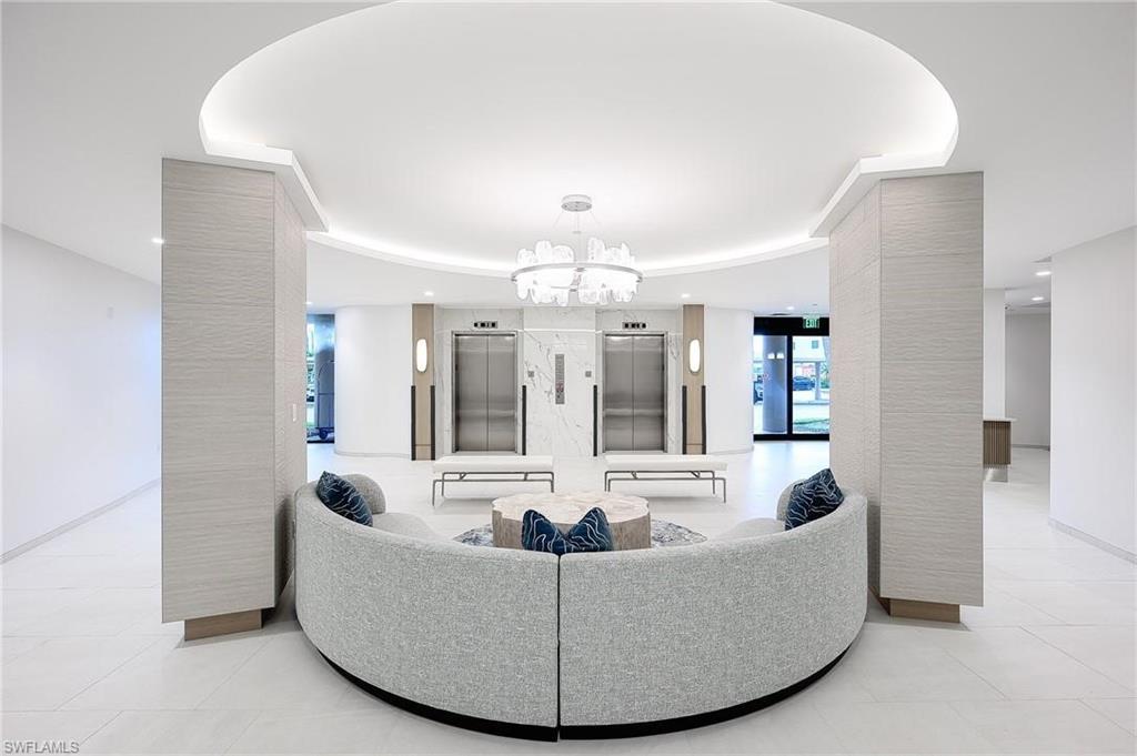 Living room with elevator and a chandelier