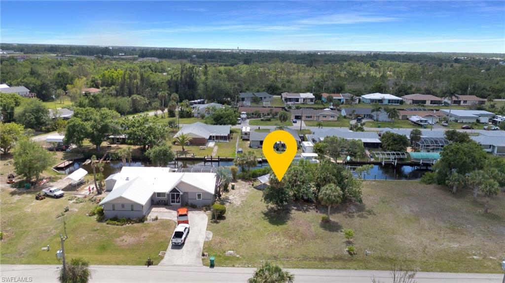 Birds eye view of property featuring a forest view, a residential view, and a water view