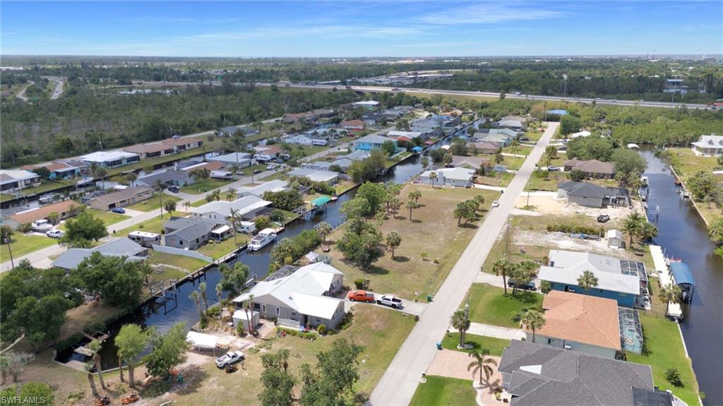 Drone / aerial view with a residential view and a water view