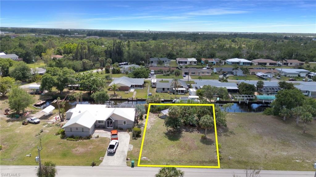 Drone / aerial view with a forest view, a water view, and a residential view
