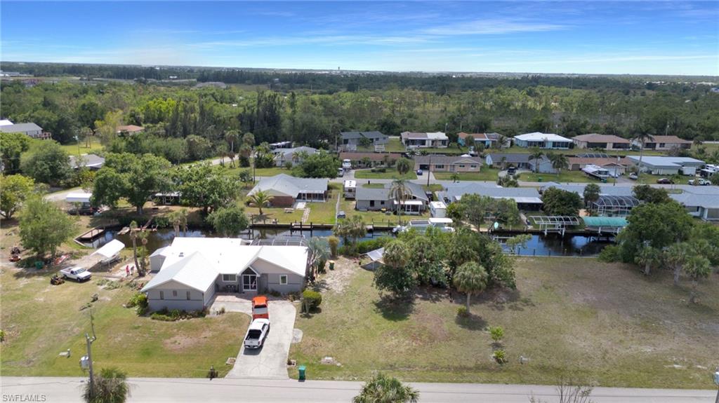 Bird's eye view featuring a residential view, a wooded view, and a water view
