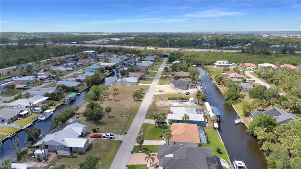 Aerial view featuring a residential view and a water view