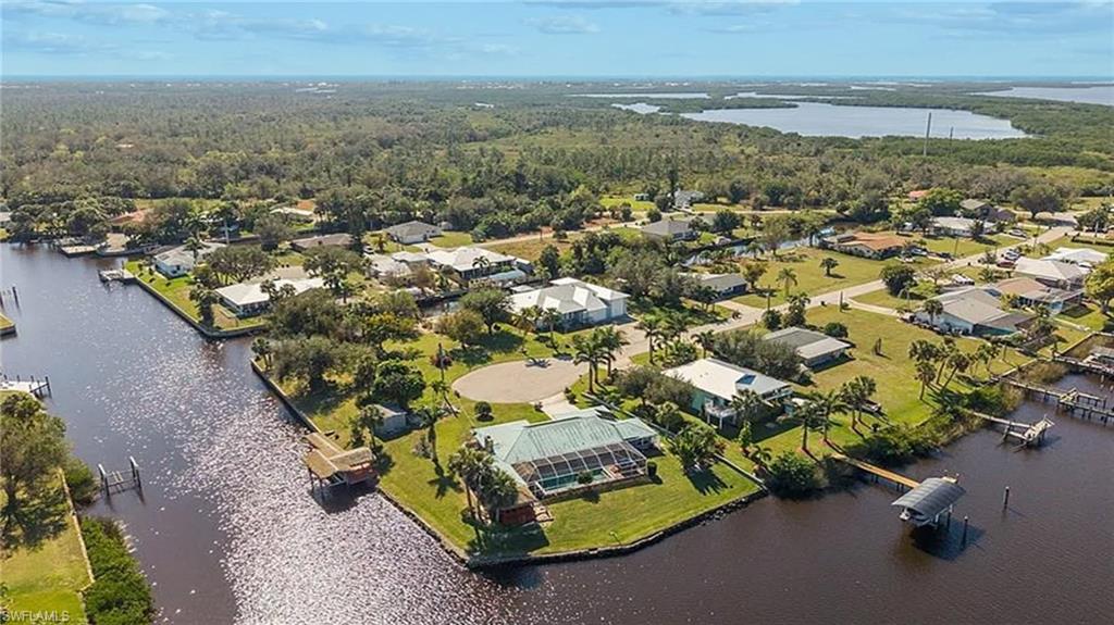 Bird's eye view with a water view, a residential view, and a wooded view