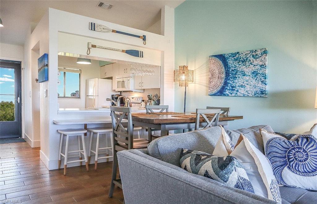 Dining space featuring baseboards, visible vents, and dark wood-type flooring