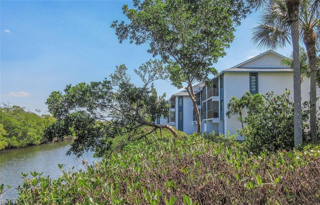 View of side of property with a water view and stucco siding