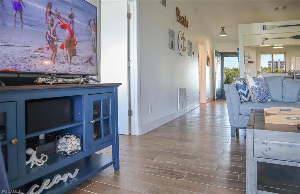 Living room featuring visible vents and wood finished floors