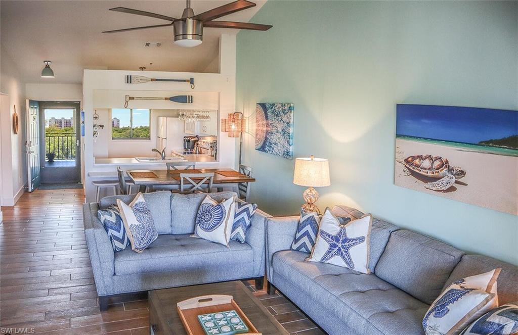 Living area with wood finished floors and a ceiling fan