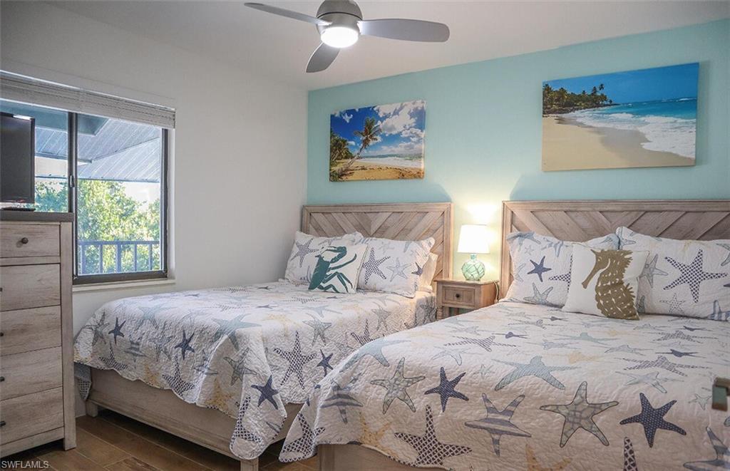 Bedroom with ceiling fan and wood finished floors