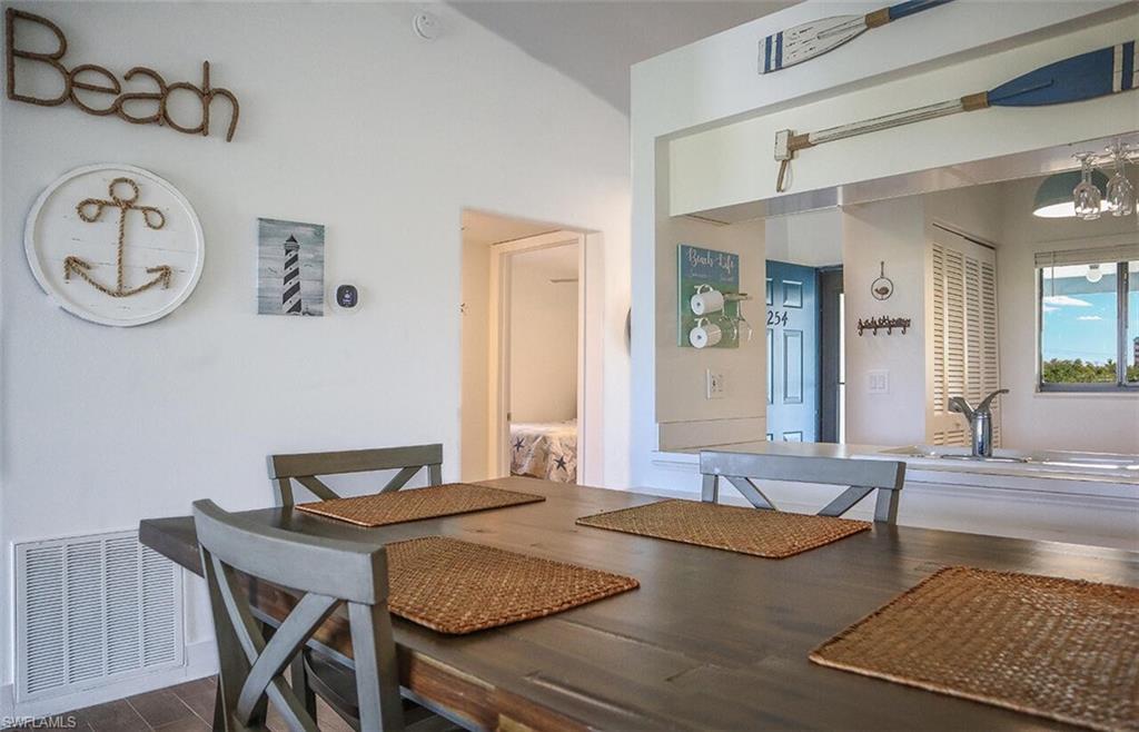 Dining space with visible vents, a chandelier, and dark wood-style floors