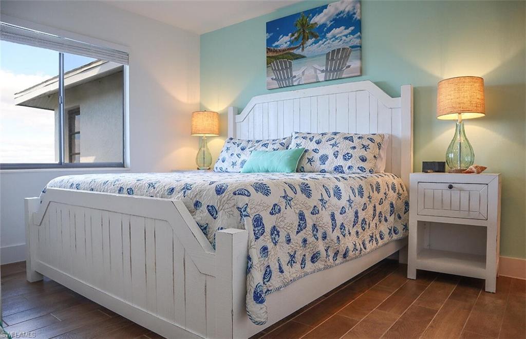 Bedroom featuring wood finished floors and baseboards