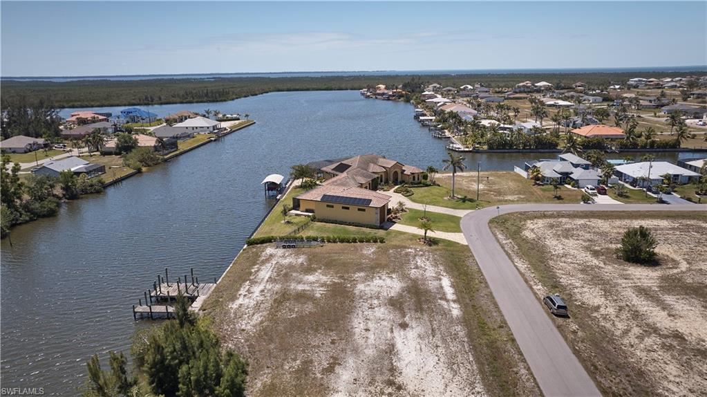 Drone / aerial view with a residential view and a water view