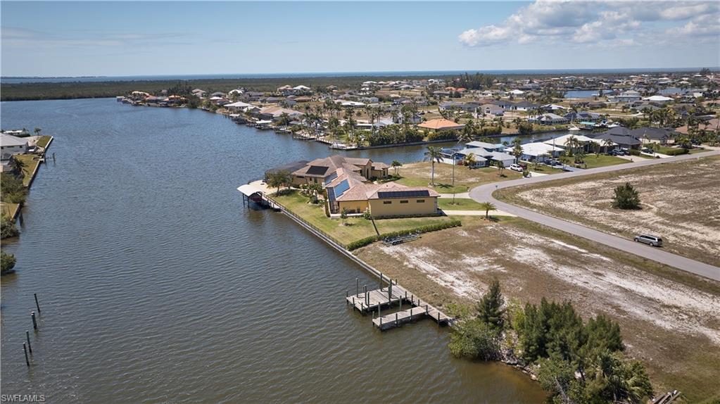 Birds eye view of property with a residential view and a water view