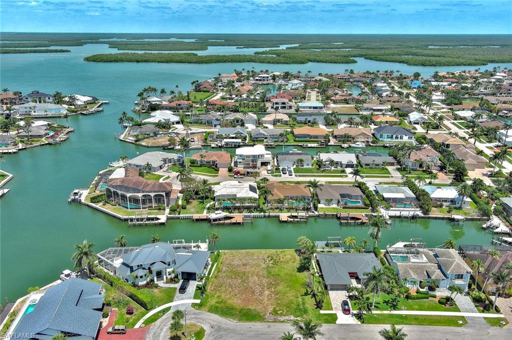 Birds eye view of property with a water view and a residential view