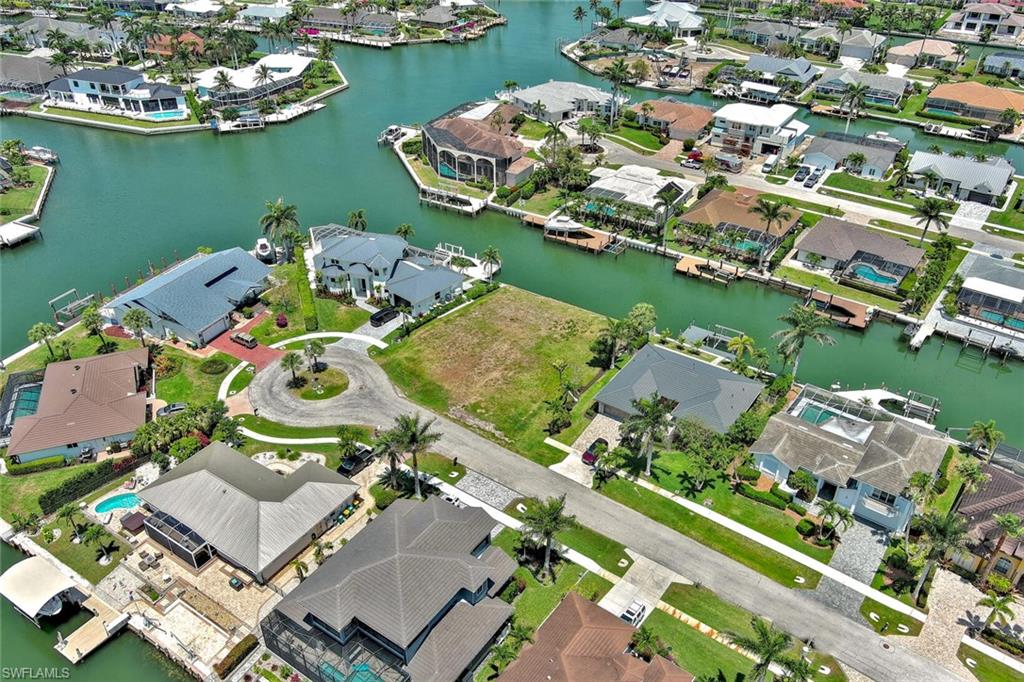 Birds eye view of property featuring a residential view and a water view