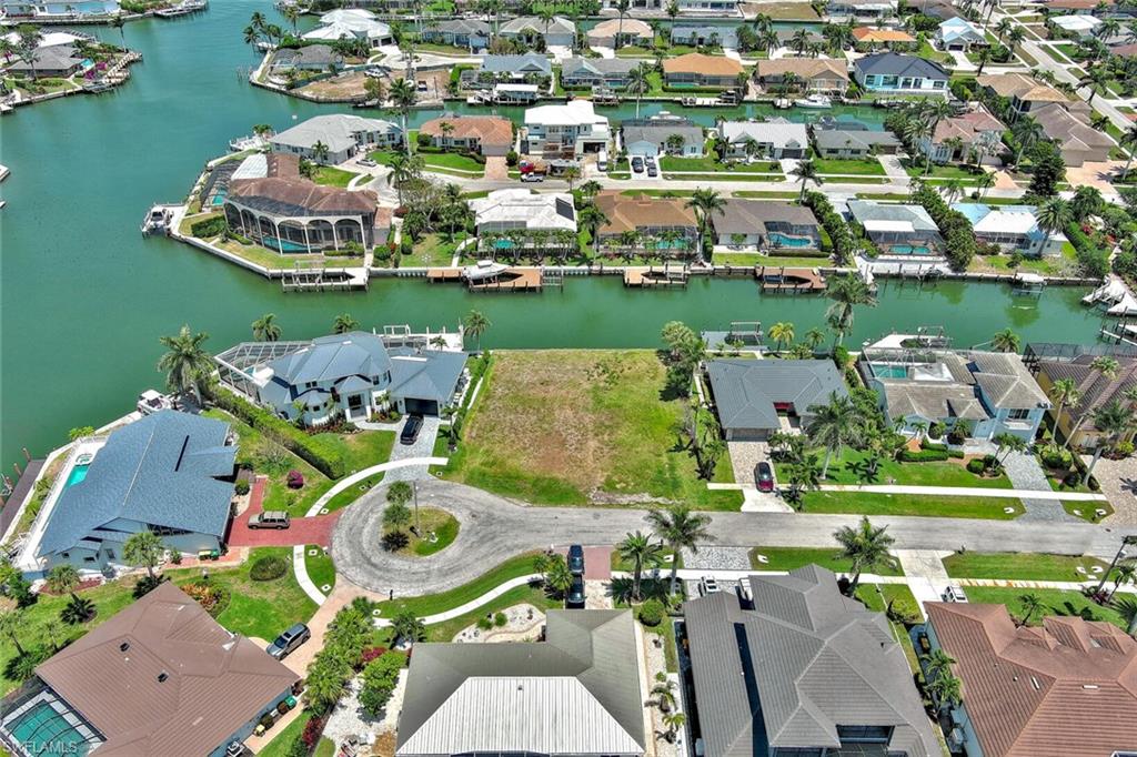 Birds eye view of property with a water view and a residential view