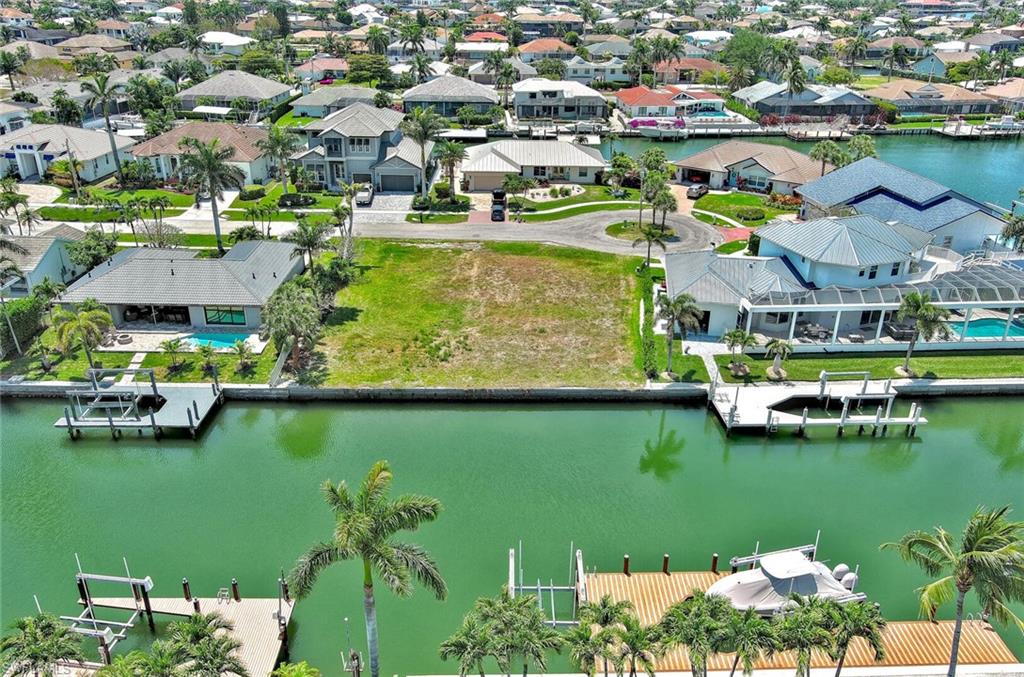 Drone / aerial view with a water view and a residential view