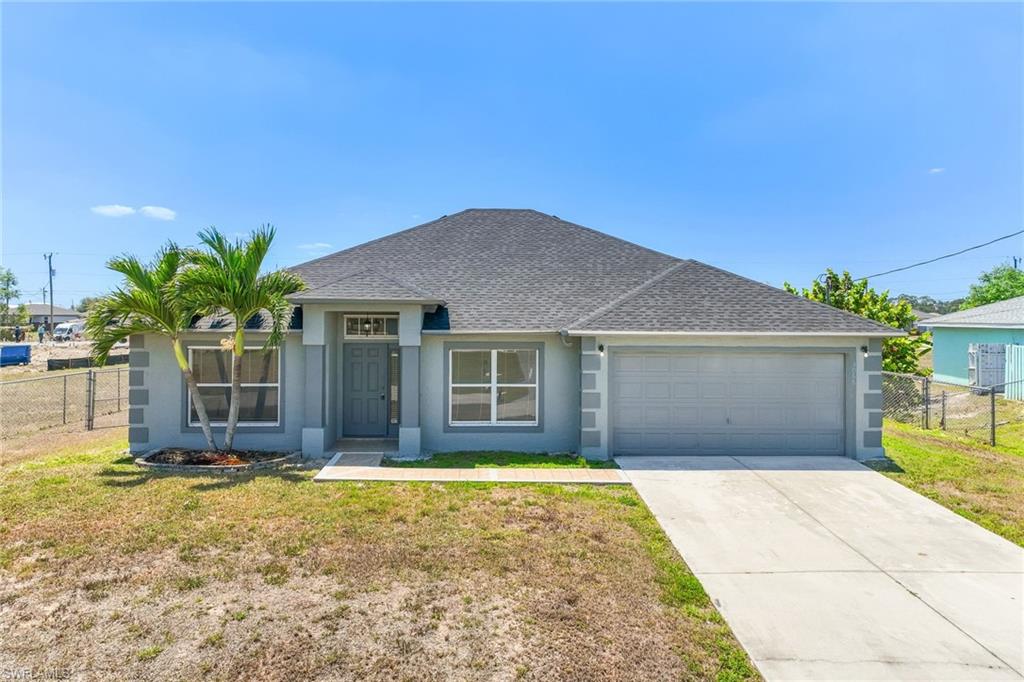 Single house featuring stucco siding, an attached garage, fence, and a shingled roof