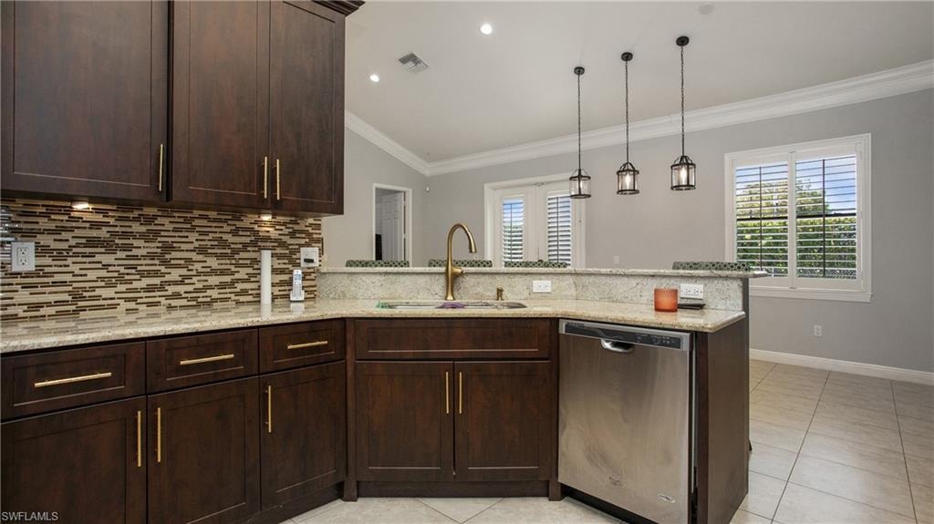 Kitchen featuring stainless steel dishwasher, a sink, a peninsula, tasteful backsplash, and ornamental molding