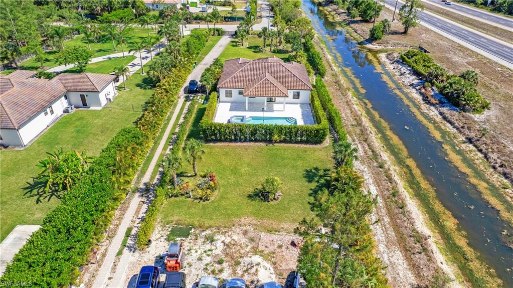 View from above of property with a pool area and a nearby body of water