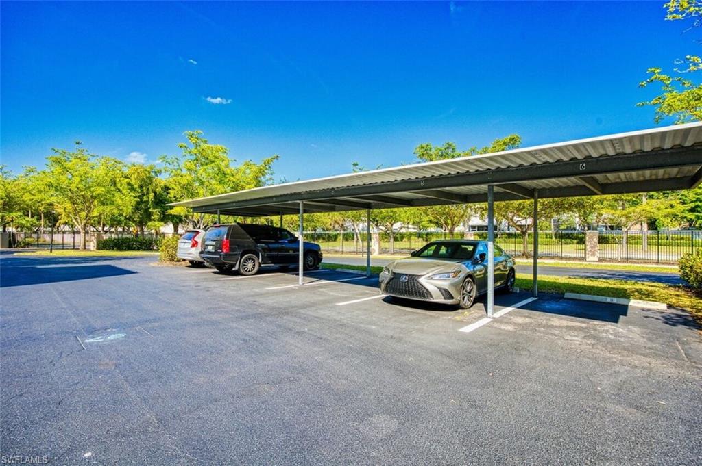 Covered parking lot featuring fence