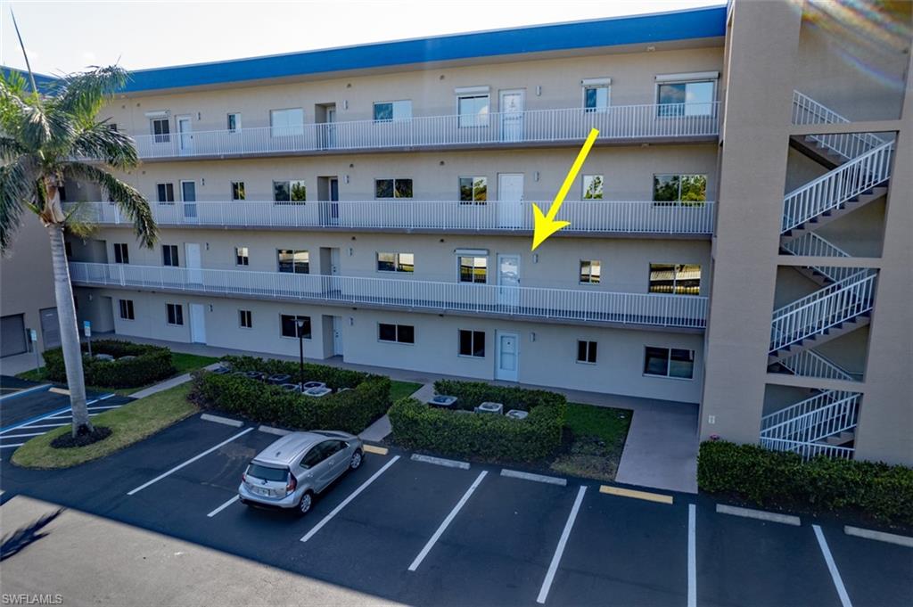 View of building exterior with uncovered parking