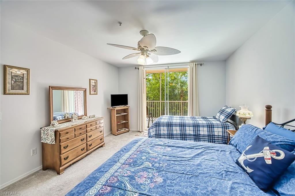 Bedroom featuring light carpet, baseboards, access to outside, and ceiling fan